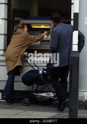 American actor/comedian Rich Hall draws cash out and forgets to grab his money before being reminded by an honest member of the public.   Stock Photo