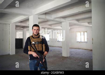 special agent  soldier portrait wearing  casual clothing with  protective army tactical gear  and weapon Stock Photo