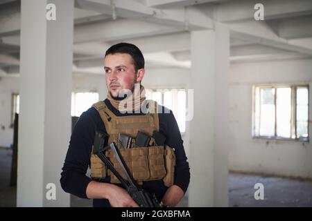 special agent  soldier portrait wearing  casual clothing with  protective army tactical gear  and weapon Stock Photo