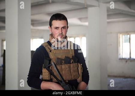 special agent  soldier portrait wearing  casual clothing with  protective army tactical gear  and weapon Stock Photo