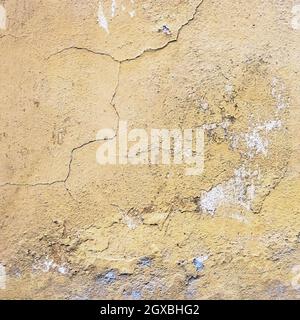 Wall old textured background. Grunge plaster wall with yellow scratched background. Old wall with peel swamp color stucco texture. Rough abstract surf Stock Photo