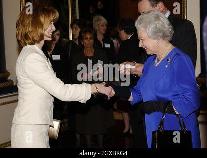 Britain's Queen Elizabeth II  meets Actress Jane Asher  at the Reception and Lunch for Women Achievers held by The Queen at Buckingham Palace in London .  Stock Photo