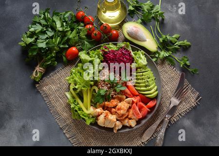 Buddha bowl or salad  with red cabbage, cherry tomatoes, grilled chicken, avocado,   lettuce,green pepper, parsley and buckwheat. Healthy food concept Stock Photo