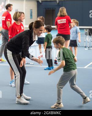 Catherine, Duchess of Cambridge takes part in a Tennis for Kids session during a visit to the Lawn Tennis Association National Tennis Centre in London on October 31, 2017. Stock Photo