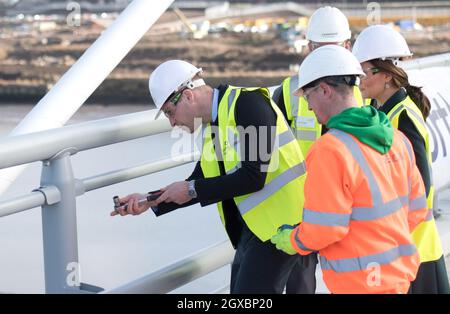 Prince William, Duke of Cambridge wears a hard-hat, high-vis vest and safety goggles as he helps screw in final nuts and bolts on the new Northern Spire bridge over the River Wear in Sunderland on February 21, 2018. Stock Photo