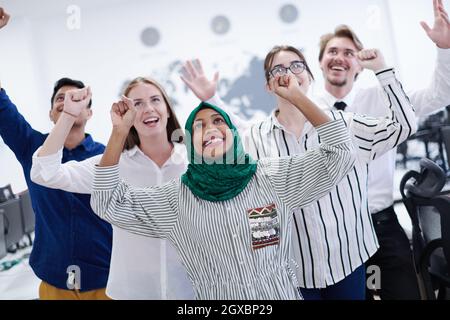 portrait of young excited multiethnics business team of software developers standing and looking at camera at modern startup office Stock Photo