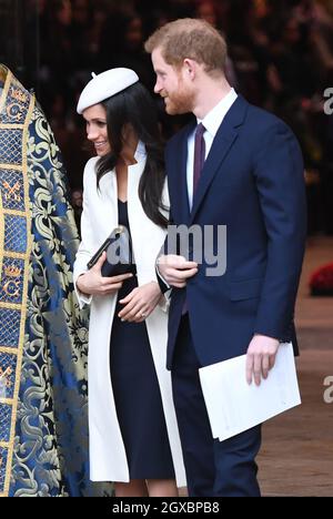 Prince Harry and Meghan Markle, wearing a cream Amanda Wakeley coat and matching hat, attend the Commonwealth Service at Westminster Abbey in London on March 12, 2018. Stock Photo