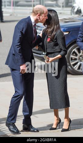 Meghan Markle wearing a black Emilia Wickstead jacket and skirt and a Philip Treacy hat is