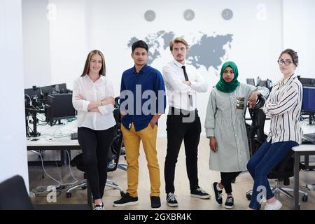 portrait of young excited multiethnics business team of software developers standing and looking at camera at modern startup office Stock Photo