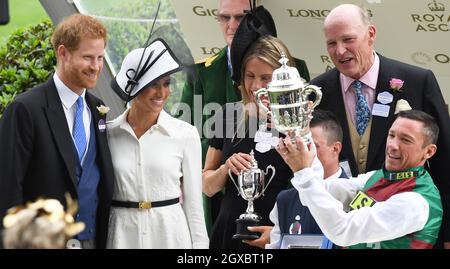 The Duke and Duchess of Sussex present the winner's trophy of the St James's Palace Stakes to jockey Frankie Dettori during the first day of Royal Ascot  on June 19, 2018 Stock Photo