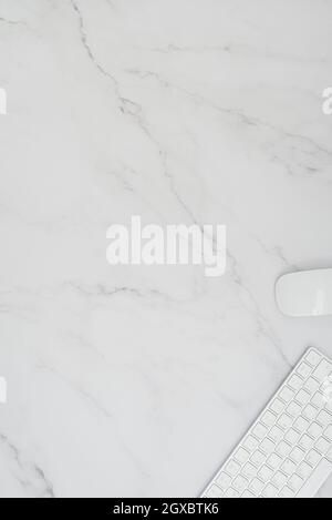 Minimalistic desktop with keyboard and mouse on marble background with copy space. Stock Photo