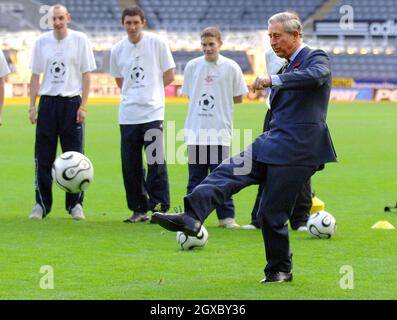 Prince Charles, Prince of Wales kicks a penalty during a visit to Newcastle United's St James' Park ground on November 8, 2006. The Royal couple are on a two-day tour of the north east of England. Anwar Hussein/EMPICS Entertainment Stock Photo