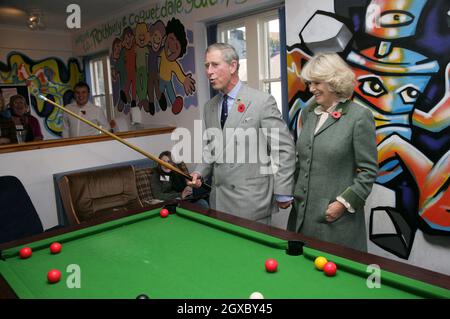 Prince Charles, Prince of Wales watched by Camilla, Duchess of Cornwall, plays pool with teenagers when they visit the Jubilee Institute at Rothbury on November 09, 2006. Anwar Hussein/EMPICS Entertainment  Stock Photo