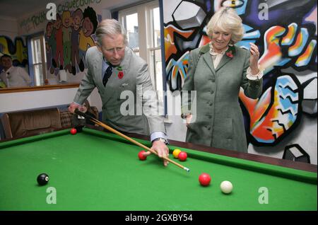 Prince Charles, Prince of Wales watched by Camilla, Duchess of Cornwall, plays pool with teenagers when they visit the Jubilee Institute at Rothbury on November 09, 2006. Anwar Hussein/EMPICS Entertainment  Stock Photo