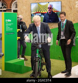 Manchester, England, UK. 5th Oct, 2021. PICTURED: Rt Hon Boris Johnson MP - UK Prime Minister seen doing a walk around of conference and seen cycling a electric e bike and also building a model zero carbon house model and operating a digger excavator. Scenes during the at the Conservative party Conference #CPC21. Credit: Colin Fisher/Alamy Live News Stock Photo