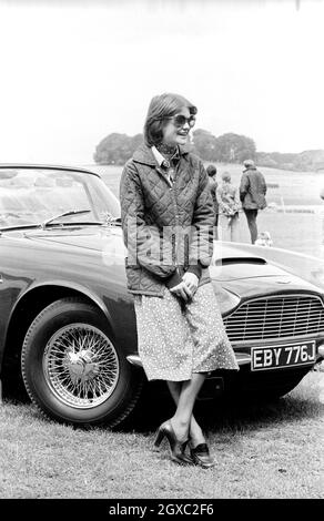 Lady Sarah Spencer (later Lady Sarah McCorquodale), a girlfriend of Prince Charles and sister of Princess Diana, stands beside Prince Charles's Aston Marton car at the Guards Polo Club in Windsor on June 29, 1977.  Stock Photo