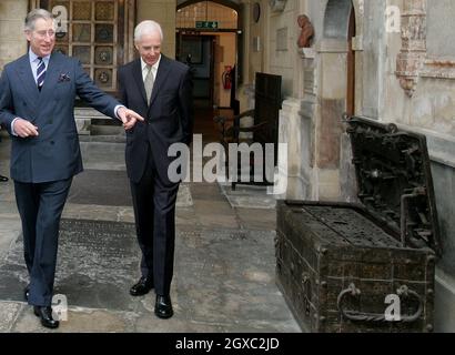 Prince Charles, Prince of Wales, accompanied by Sir Michael Graydon, points to an old trunk during a visit to Charterhouse in London on February 14, 2007. The Prince toured the historical Charterhouse buildings, including the chapel, the Norfolk Cloister and the Great Hall. Stock Photo