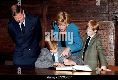 Prince William signs in on his first day at Eton College watched by his parents, the Prince and Princess of Wales and brother, Prince Harry on September 16, 1995 in Windsor, England. Stock Photo