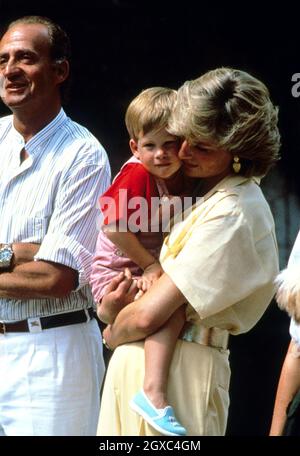Princess Diana, Princess of Wales holds Prince Harry whilst on holiday in Majorca, Spain on August 10, 1987. Also present were the Spanish Royal Family and Prince Charles, Prince of Wales. Stock Photo