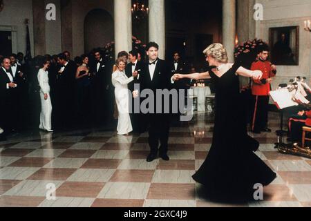 Diana, Princess of Wales dances with John Travolta at the White House, watched by President Ronald Reagan and his wife Nancy in November 9, 1985 in Washington DC. Stock Photo