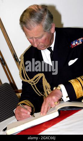 Prince Charles, Prince of Wales signs the visitors book aboard HMS Bulwark, who were deployed to Iraq last year, during a tour of HM Naval Base Davenport in Plymouth on May 9, 2007. Stock Photo