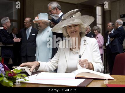 Camilla, Duchess of Cornwall signs the visitors book when she visits the National Museum of Wales in Cardiff with Prince Charles, Prince of Wales, Queen Elizabeth ll and Prince Philip on June 5, 2007. Stock Photo