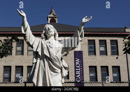A statue stands in front of the Carlow University, a private Catholic university, in Pittsburgh, Pennsylvania. Stock Photo