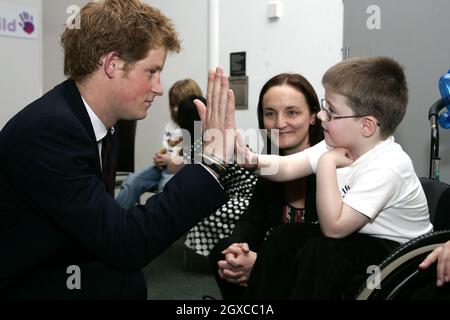 Prince Harry 'high-fives' with Christopher Anderson, who nominated Caroline Anderson for Best Nurse, during the WellChild Childrens' Health Awards ceremony in London. Stock Photo