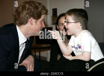 Prince Harry chats to Christopher Anderson, who nominated Caroline Anderson for Best Nurse, during the WellChild Childrens' Health Awards ceremony in London. Stock Photo