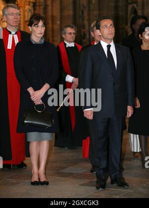 French President Nicolas Sarkozy stands with his wife Carla Bruni-Sarkozy during a visit to Westminster Abbey in London where he laid a wreath on the tomb of the unknown soldier during the first day of their state visit to the UK. Stock Photo