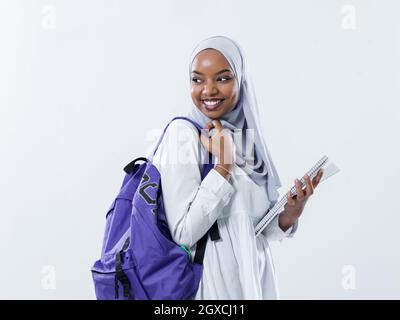 portrait of happy african modern muslim female student standing against white background wearing traidiional sudan muslim hijab fashion Stock Photo