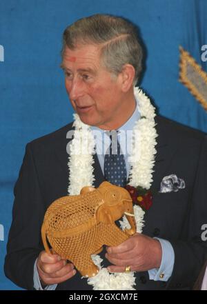 Prince Charles, Prince of Wales holds an elephant gift given to him to celebrate the Hindu festival of Holi during a visit to the Swaminarayan School in London, England. Stock Photo