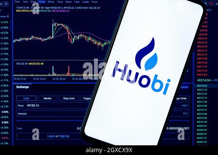 A smartphone with the Huobi logo on the background of the live trading webpage. Huobi dashboard. Stock Photo