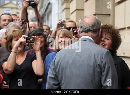 Prince Charles, Prince of Wales meets 75 year old Patricia Blair Gould, who cheekily demands a kiss, as he arrives to open the new Highgrove Shop in Bath on June 9, 2010. The Highgrove Shop sells organic food and lifestyle products for the home and garden and profits for sales are donated to The Prince's Charities Foundation. Stock Photo