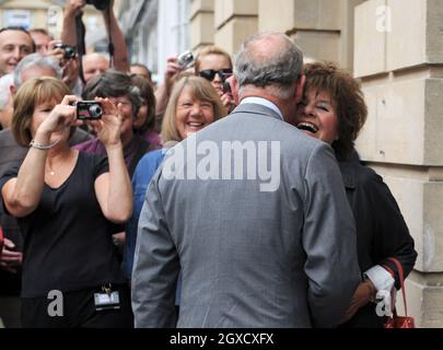 Prince Charles, Prince of Wales meets 75 year old Patricia Blair Gould, who cheekily demands a kiss, as he arrives to open the new Highgrove Shop in Bath on June 9, 2010. The Highgrove Shop sells organic food and lifestyle products for the home and garden and profits for sales are donated to The Prince's Charities Foundation. Stock Photo