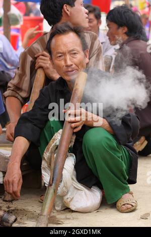 Vietnamese man smoking tobacco with traditional bamboo pipe, Old ...