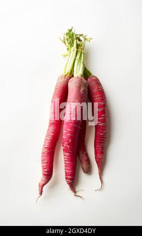 Red daikon radish on white background. Healthy asian ingredient for vegetarian dish Stock Photo