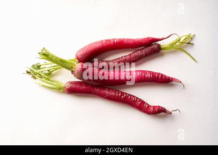 Red daikon radish on white background. Healthy asian ingredient for vegetarian dish Stock Photo