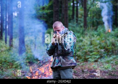 angry terrorist militant guerrilla soldier warrior in forest Stock Photo