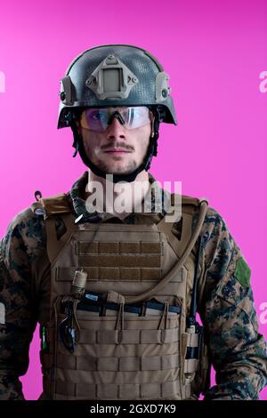 american  marine corps special operations modern warfare soldier with fire arm weapon and protective army tactical gear ready for battle on pink backg Stock Photo