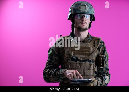 soldier using tablet computer hands closeup pnk background Stock Photo