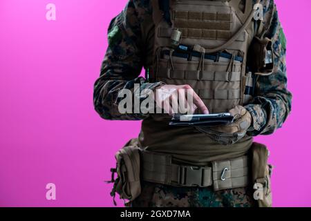 soldier using tablet computer hands closeup pnk background Stock Photo