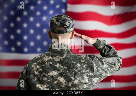 Military US Soldier Saluting Flag. Army Veteran Stock Photo