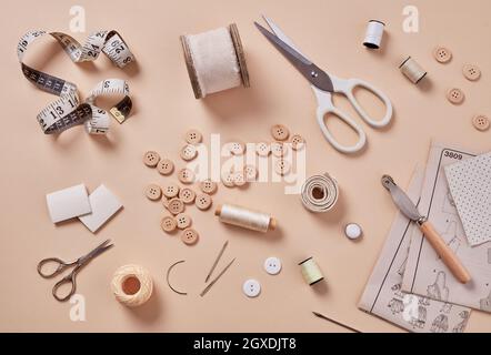 Materials and accessories for sewing - fabric, pins, thread, buttons, top view Stock Photo