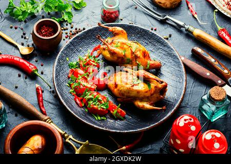 Roasted whole quail and spring vegetable salad Stock Photo