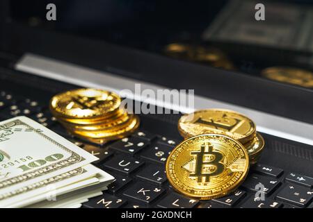Bitcoins coin and banknotes on keyboard computer. Close up of  bitcoin crypto currency coins Stock Photo