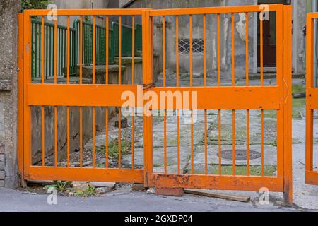 Orange Metal Bars Gate Entrance to Car Parking Place Stock Photo