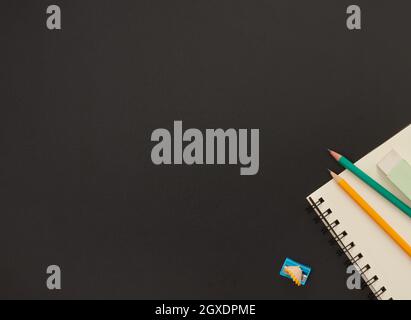 Blank paper notepad and school supplies on blackboard Stock Photo