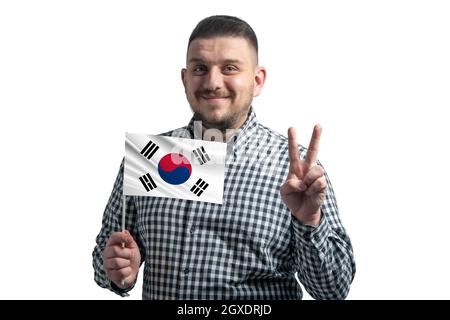 White guy holding a flag of South Korea and shows two fingers isolated on a white background. Stock Photo