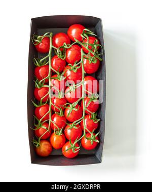 Fresh cherry tomatoes in cardboard box isolated on white background, top view Stock Photo